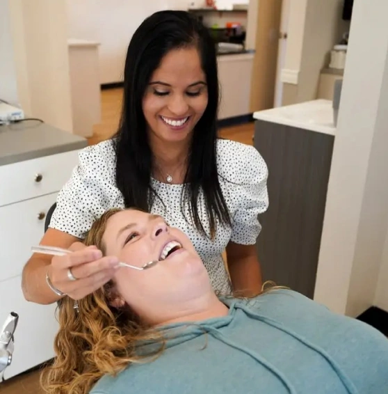 Dentist working on a woman during a dental crown procedure