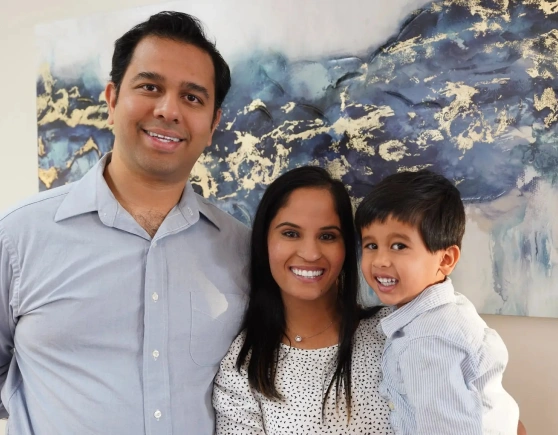 Dr Yashoni Shah posing for a photo with a man and a child