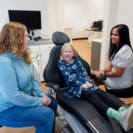 Dental hygienist and dentist working with a patient for fluoride treatment