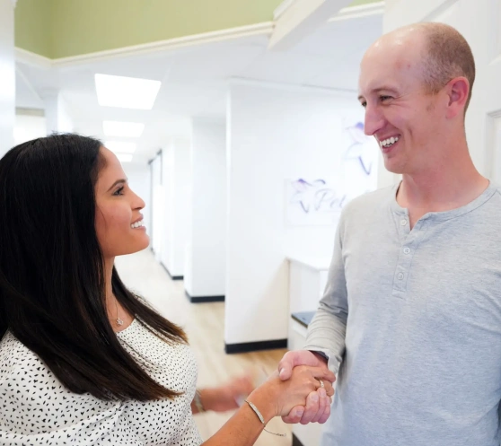 Dentist and patient having a friendly conversation at the dental office