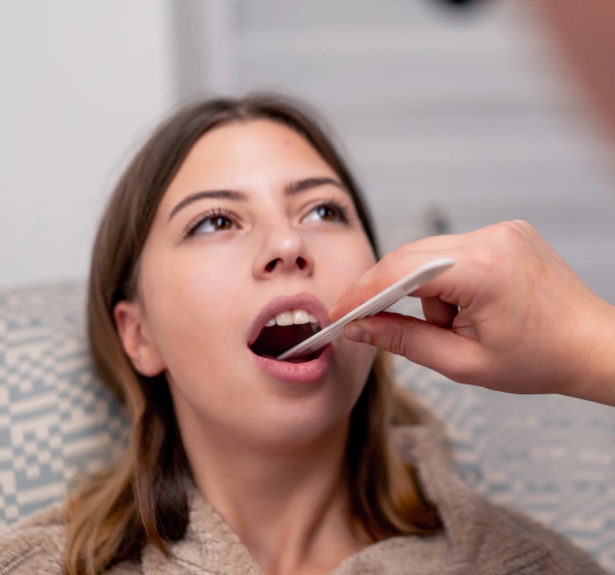 Woman undergoing an oral cancer screening exam