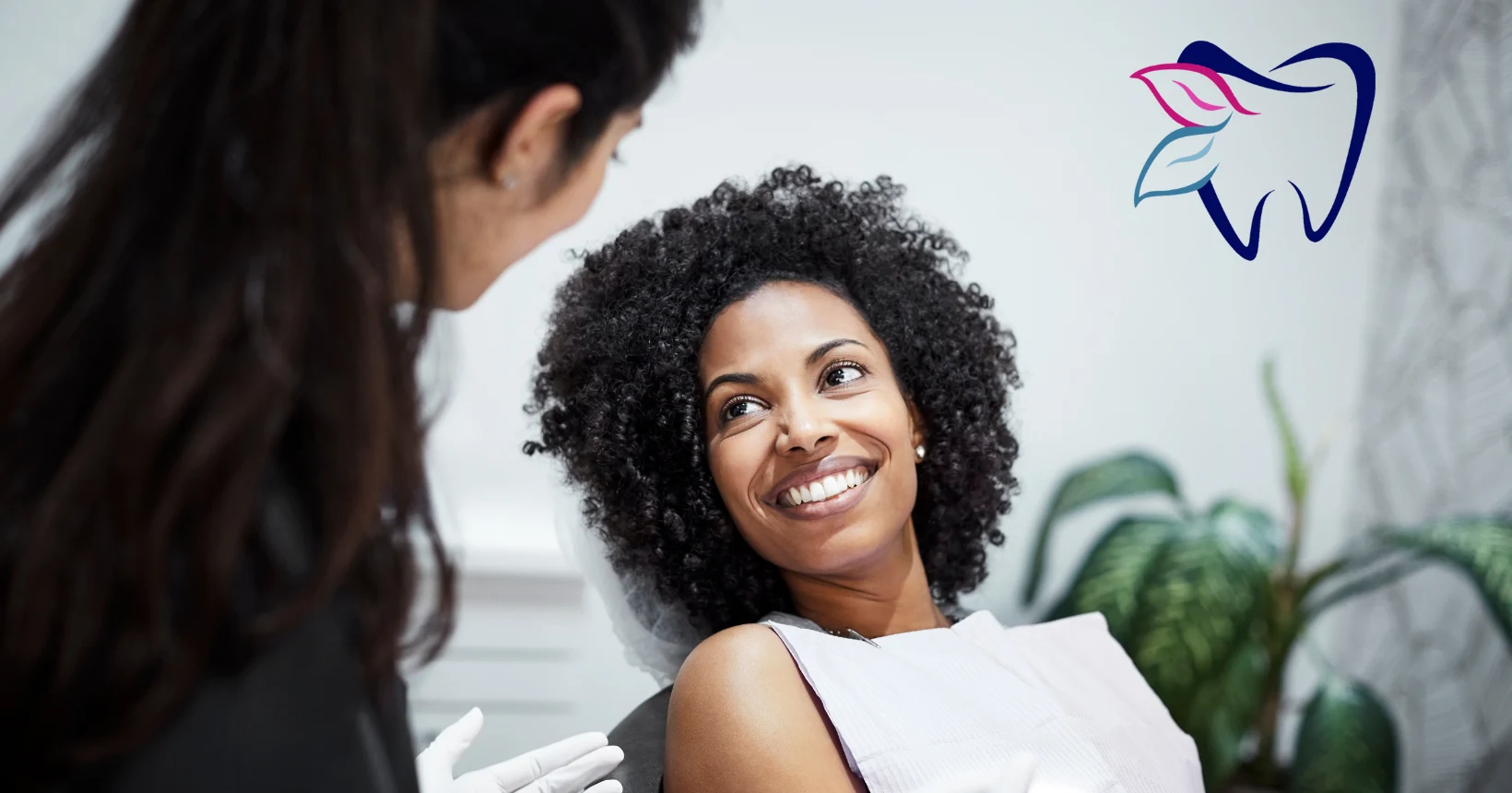 Woman with curly hair smiling for a dental technology guide