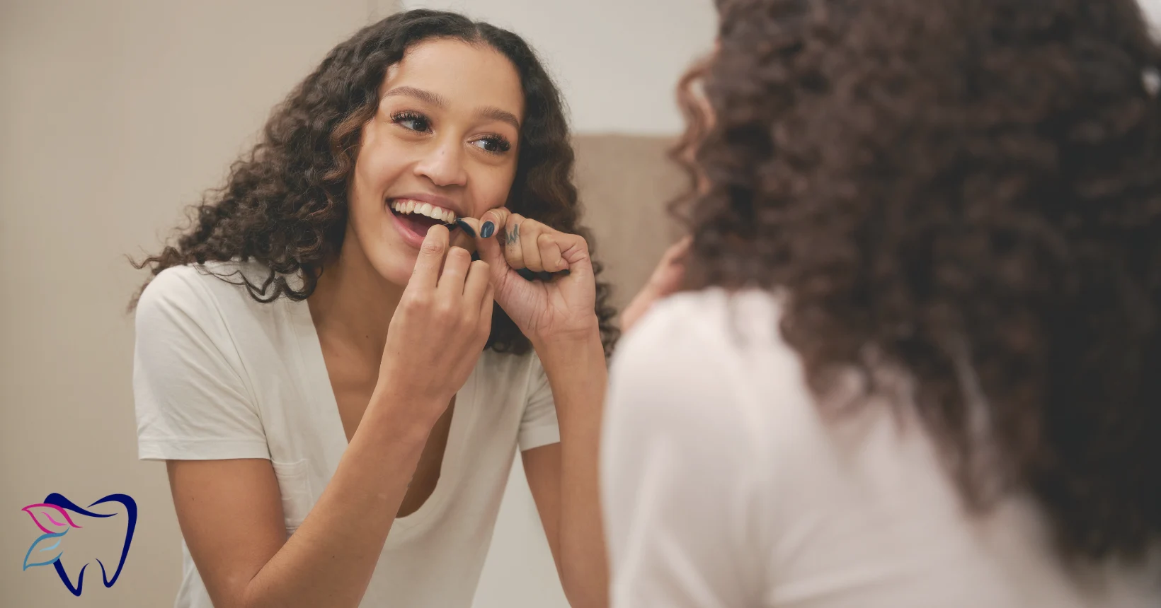 Woman flossing her teeth near a mirror