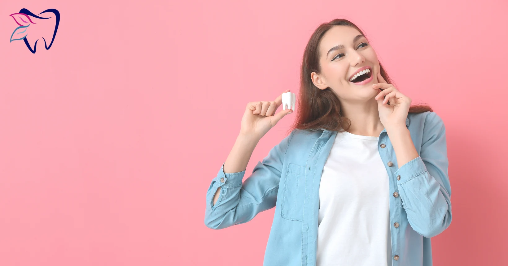 Woman holding a tooth model and smiling