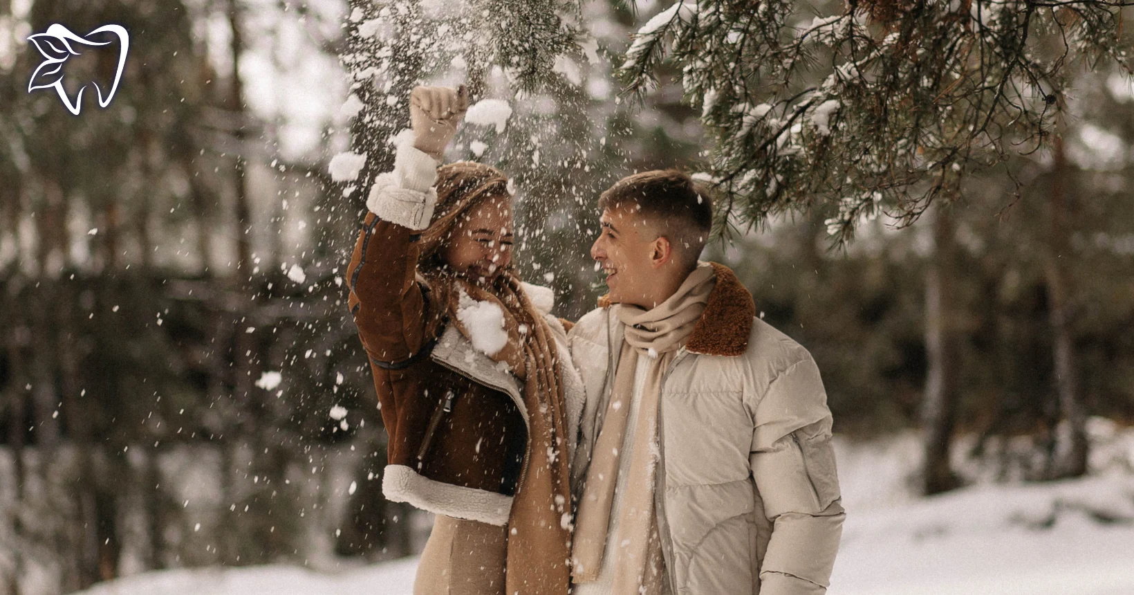 A couple playing in the snow